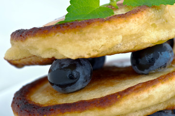 Delicious pancakes close up, with fresh blueberries and maple syrup