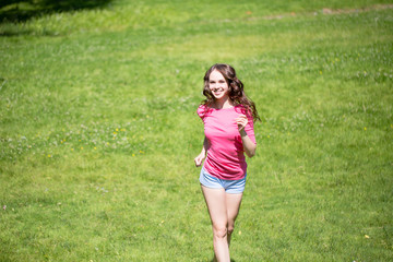 Young beautiful woman running in the park