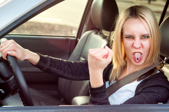 Angry pissed off aggressive student girl driving car