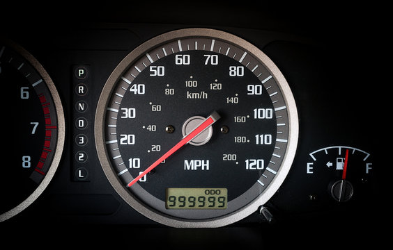 Car dashboard odometer with 999999 miles on it
