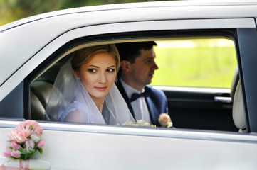 Portrait of bride groom in car window