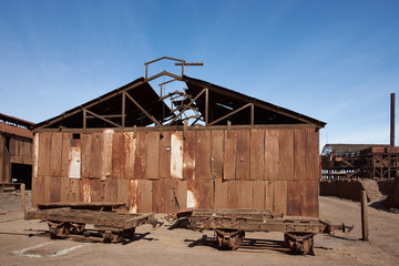 Derelict and rusting buildings at the historic Santa Laura Saltpeter Works in the Atacama Desert near Iquique in Chile. The site is now an open air museum and a Unesco World Heritage SIte.