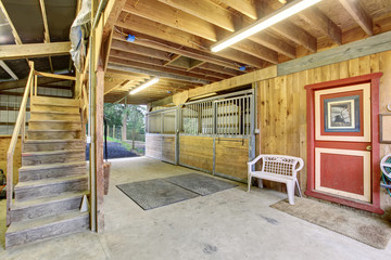 Authentic barn with stalls and a red door.