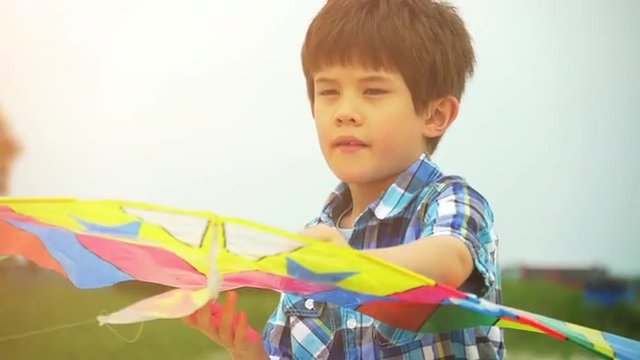 Little boy flying a kite in slow motion, happy lifestyle stock video clip 