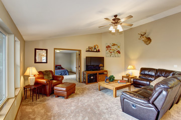 Cozy living room with brown leather couch.