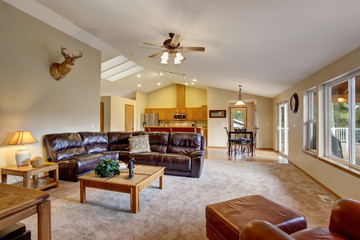 Cozy living room with brown leather couch.