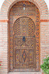 GRANADA, SPAIN - MAY 30, 2015: The door of house in mudejar style.