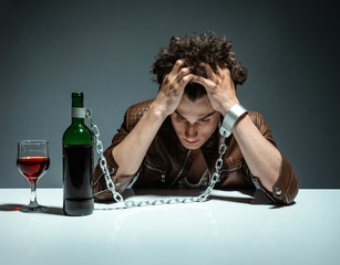 Intoxicated man sitting alone