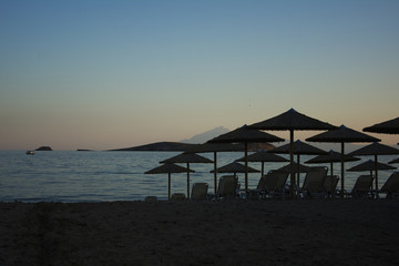 Parasol and sunbeds at sunset
