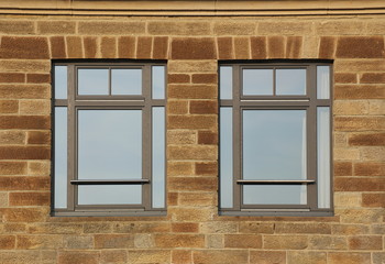Fototapeta na wymiar Facade made from freestones with two common modern windows