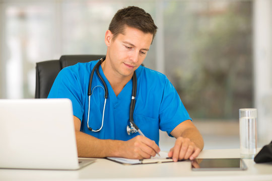 Male Nurse Writing Medical Reports