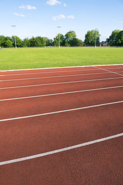Athletic running track in modern red rubber close-up abstract background