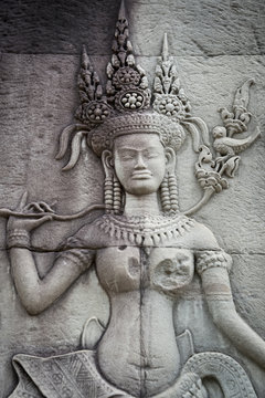 Sculptural relief in stone carving of traditional female goddess known as an apsara at Angkor Wat, Cambodia