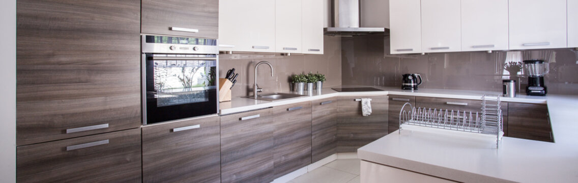 Wooden cupboards in cozy kitchen