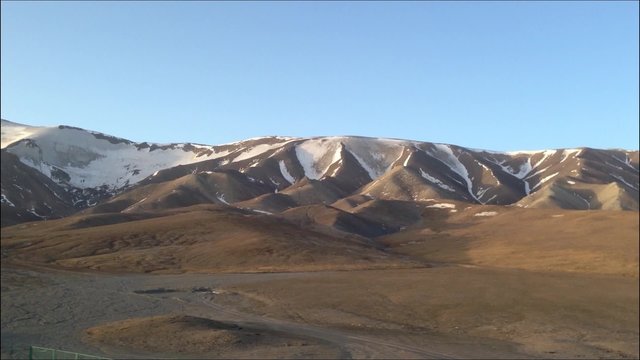 Landscape of snow mountains in Tibet at slow speed in the morning taken from the train Shanghai to Lhasa in China 2015.
