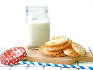 Breakfast set, glass of milk, snack on wooden plate