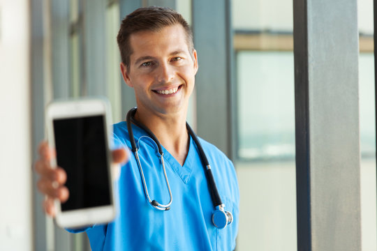 male doctor holding smart phone