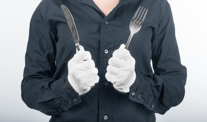 Woman hands holding a fork and a knife