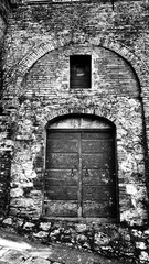 Wooden door in Tuscany, Italy in black and white