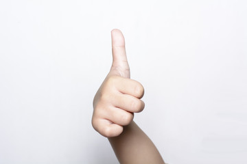 Girl raising one fingers up on hand that is thumb up its shows superb or excellent symbol on white background.
