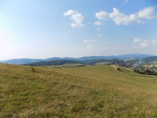 Meadow, village, forests and sky