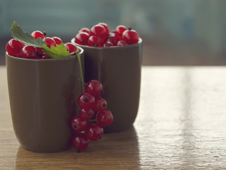 Red currants on the wooden background