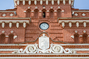 Clock and coat of arms on the railway station in Kazan.
