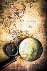 old map with compass and Magnifier