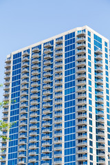 Fototapeta premium Blue Glass Condo Tower with White Balconies