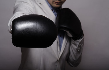 businessman in black boxing gloves