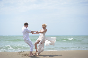 Happy wedding couple on beach