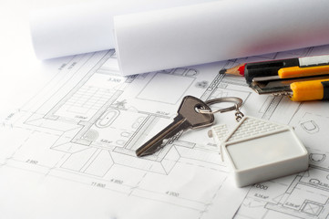 House keys on a house plan blueprint concept for new house desig