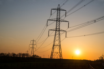 Supplying power at sunset, small wind turbine in the background.