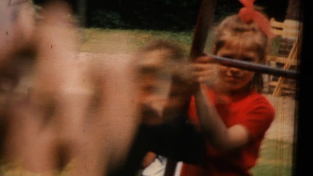 AMSTERDAM, NETHERLANDS - JUNE 10: Children swinging on a swing in the backyard on June 10, 1967 in Amsterdam, Netherlands.