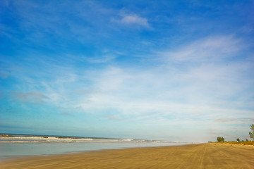 Fototapeta na wymiar Ilha Comprida beach, São Paulo - Brazil. Waves in a sunny day at the end of brazilian island.