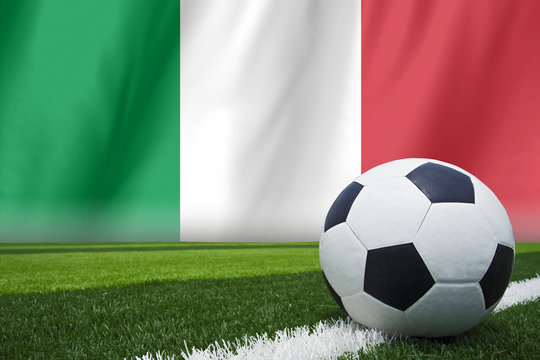 Italy waving flag and soccer ball on grass