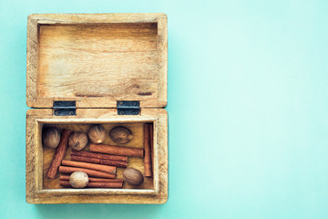 Cinnamon sticks and nutmegs in rustic box  