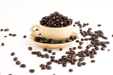 Cup full of coffee beans on on white background
