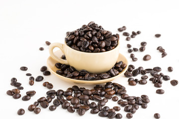 Cup full of coffee beans on on white background