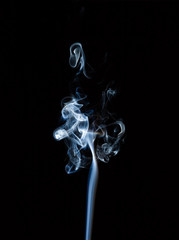 Incense smoke on a black background.