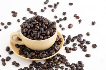 Cup full of coffee beans on on white background