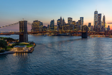 Fototapeta na wymiar New York City Brooklyn Bridge buildings evening sunset skyline