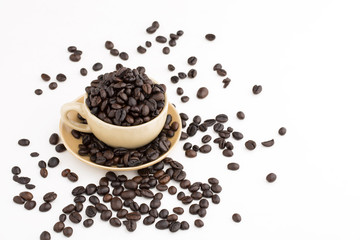Cup full of coffee beans on on white background