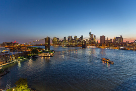New York City Brooklyn Bridge buildings evening sunset skyline © blvdone