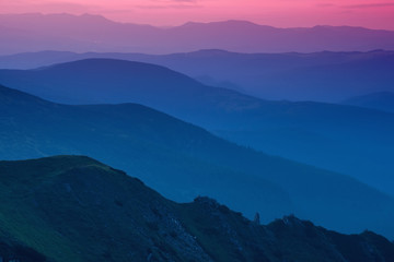 Hills lines in mountain valley during sunset. Natural summer mountain landscape