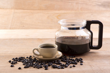 man's hand holding and pouring coffee into cup