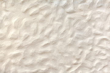 Weiss beiger Verputz mit buckeliger Oberfläche 