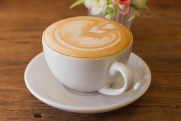 Coffee latte art on the wood desk