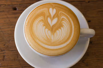 Coffee latte art on the wood desk