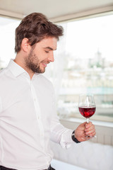 Handsome young man is relaxing with alcohol drink